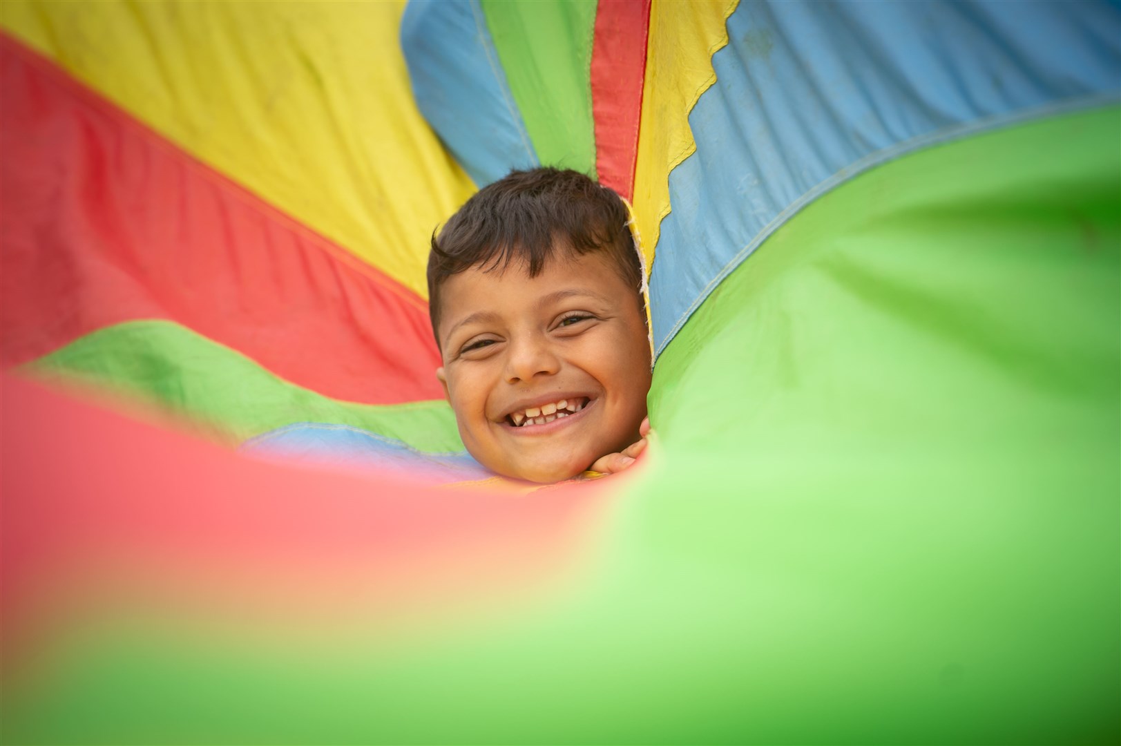 A play scheme at The Field in Alness run by The Place youth group put smiles on many faces – amongst them Omar Ali. Picture: Callum Mackay