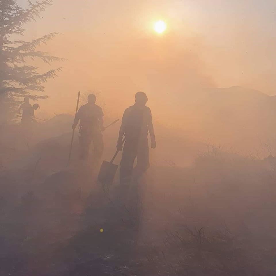 Shadowy figures emerge amidst plumes of smoke that could be seen for miles around.