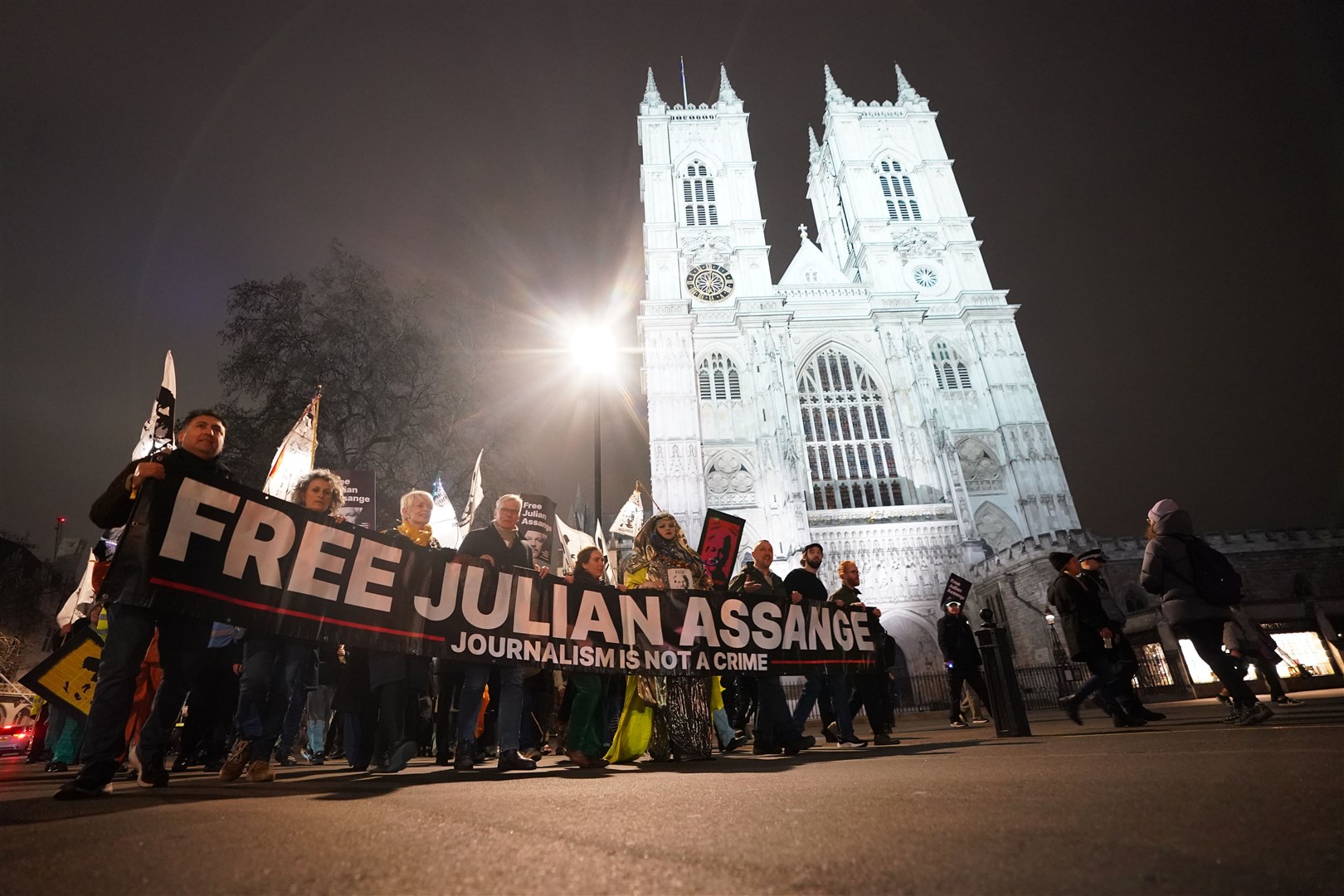Campaigners pressing for the release of WikiLeaks founder Julian Assange take part in a demonstration during a Night Carnival outside Westminster Abbey (James Manning/PA)