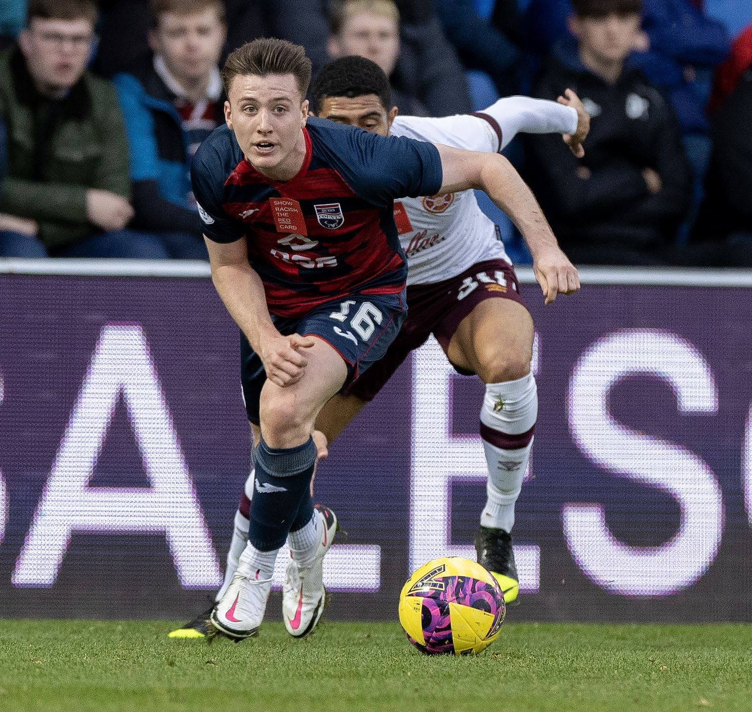 Picture - Ken Macpherson. Ross County(1) v Hearts(2). 30/10/22. Ross County's George Harmon gets away from Hearts' Josh Ginnelly.