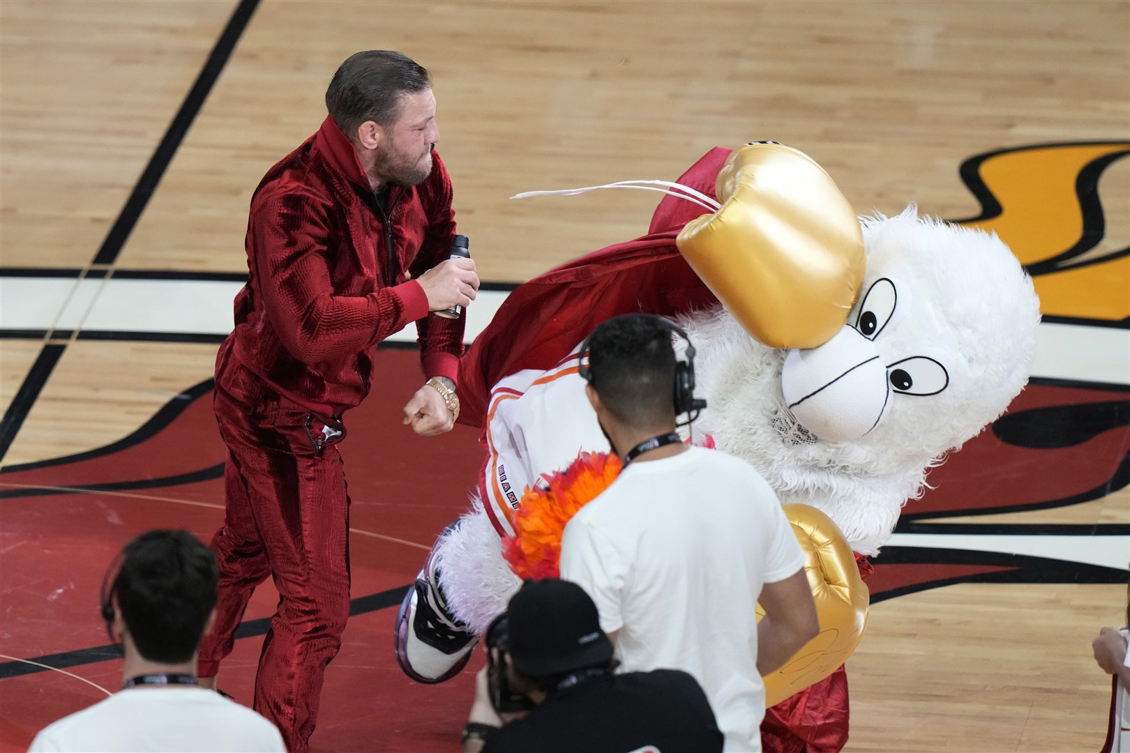 Conor McGregor punches Burnie, the Miami Heat mascot, during a publicity stunt in game four of the NBA Finals (Lynne Sladky/AP)