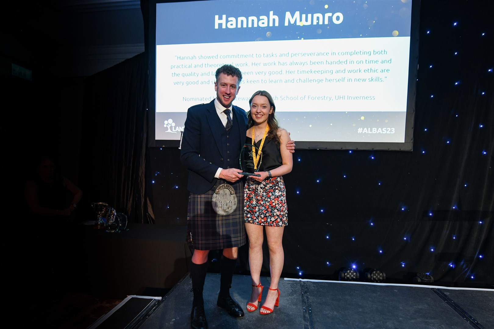 Hannah Munro of Tain, the Lantra Trees and Timber Learner of theYear award with ALBAS host Cammy Wilson.