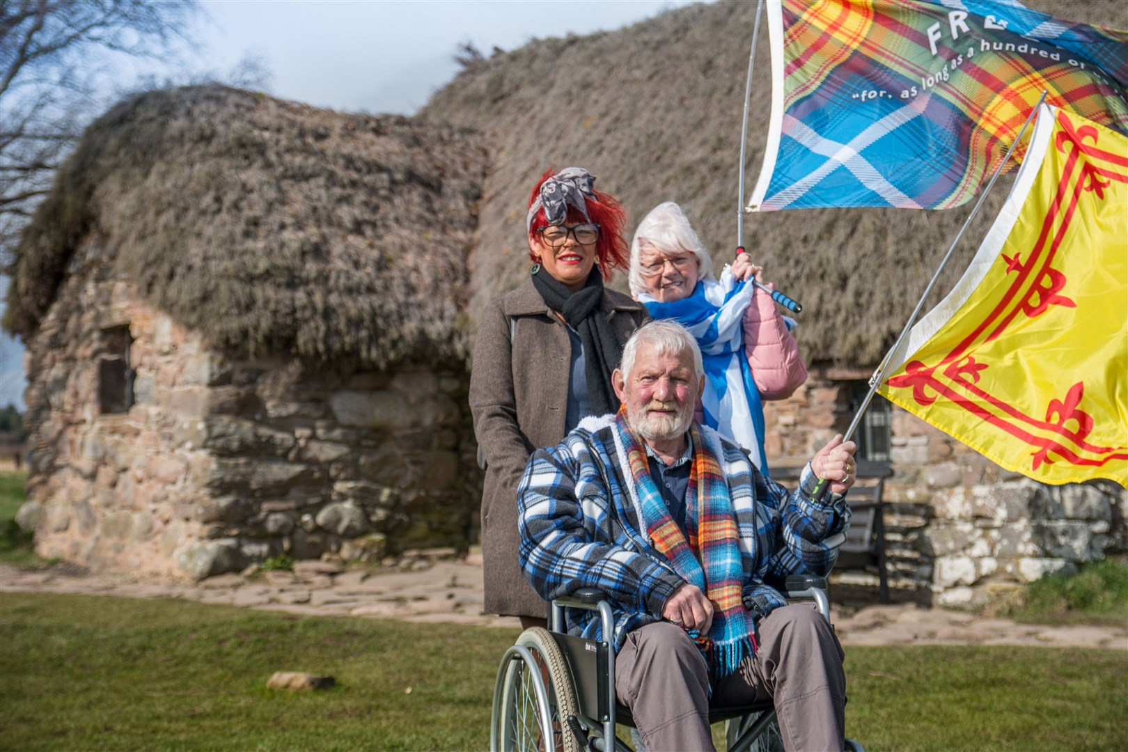 Visitors outside Leanach Cottage at Culloden Battlefield.