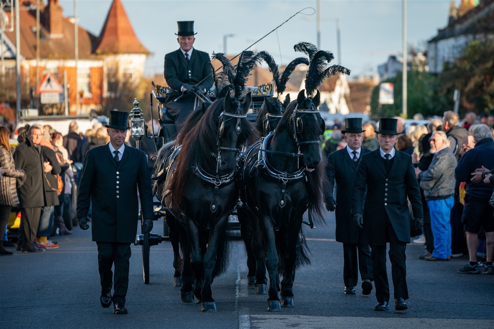 Members of the public pay their respects as the horse drawn hearse carrying the coffin of Sir David Amess, arrives at his constituency office (Aaron Chown/PA)
