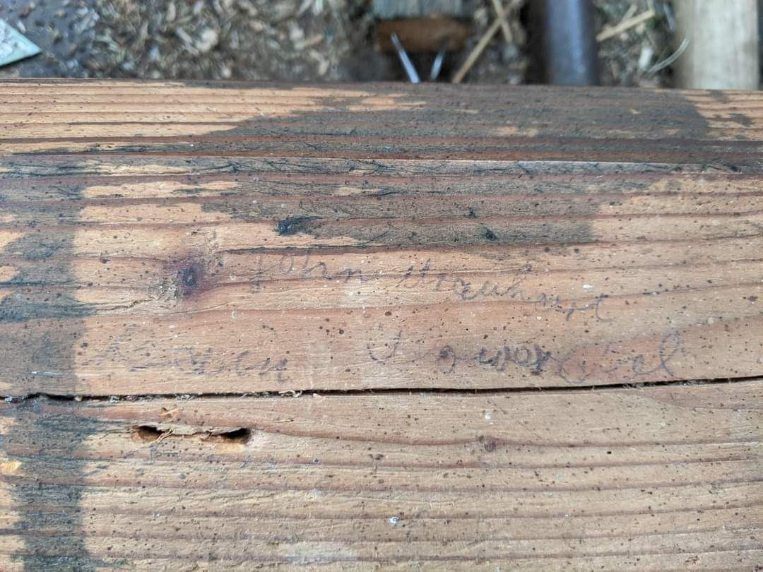 Graffiti on a stable stall bears the name of John Urquhart.