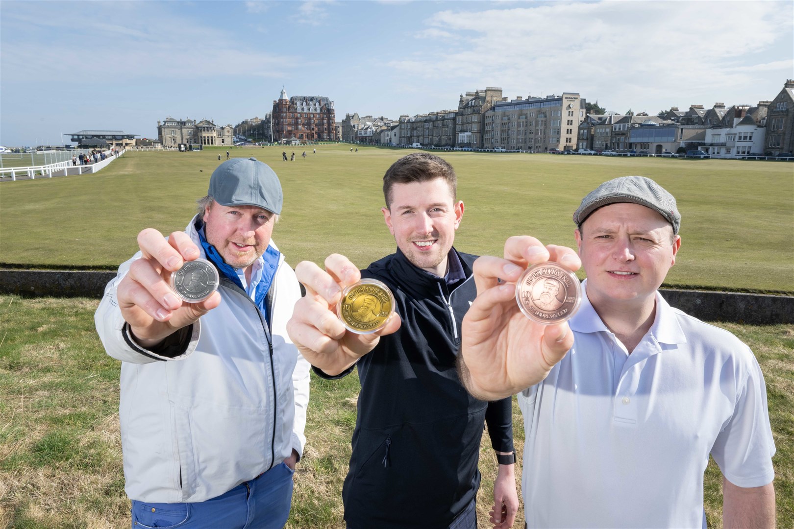 Dave Harris (left), with Bonnie Wee Golf tour specialist team Cam Howe (centre) and director Stew Morrison, display the Old Tom Morris Trail commemorative coins. (Picture Michal Wachucik, Abermedia)