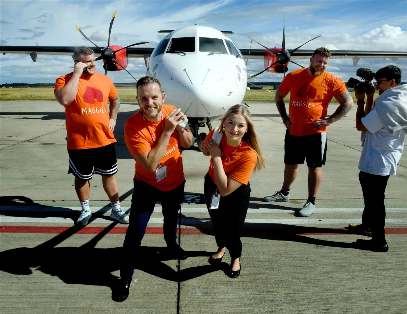 Maggies' Andrew Benjamin and Mia Pimm pulling the plane while Luke Stoltman and Tom Stoltman take a break.  Pictured: James Mackenzie.