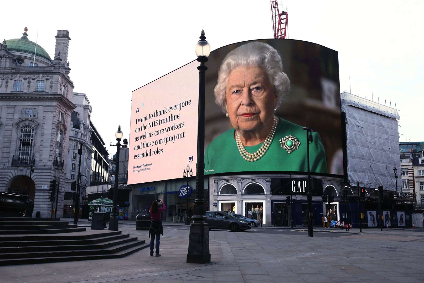 An image of the Queen and quotes from her broadcast in April on the coronavirus pandemic are displayed on lights in London’s Piccadilly Circus (Yui Mok/PA)
