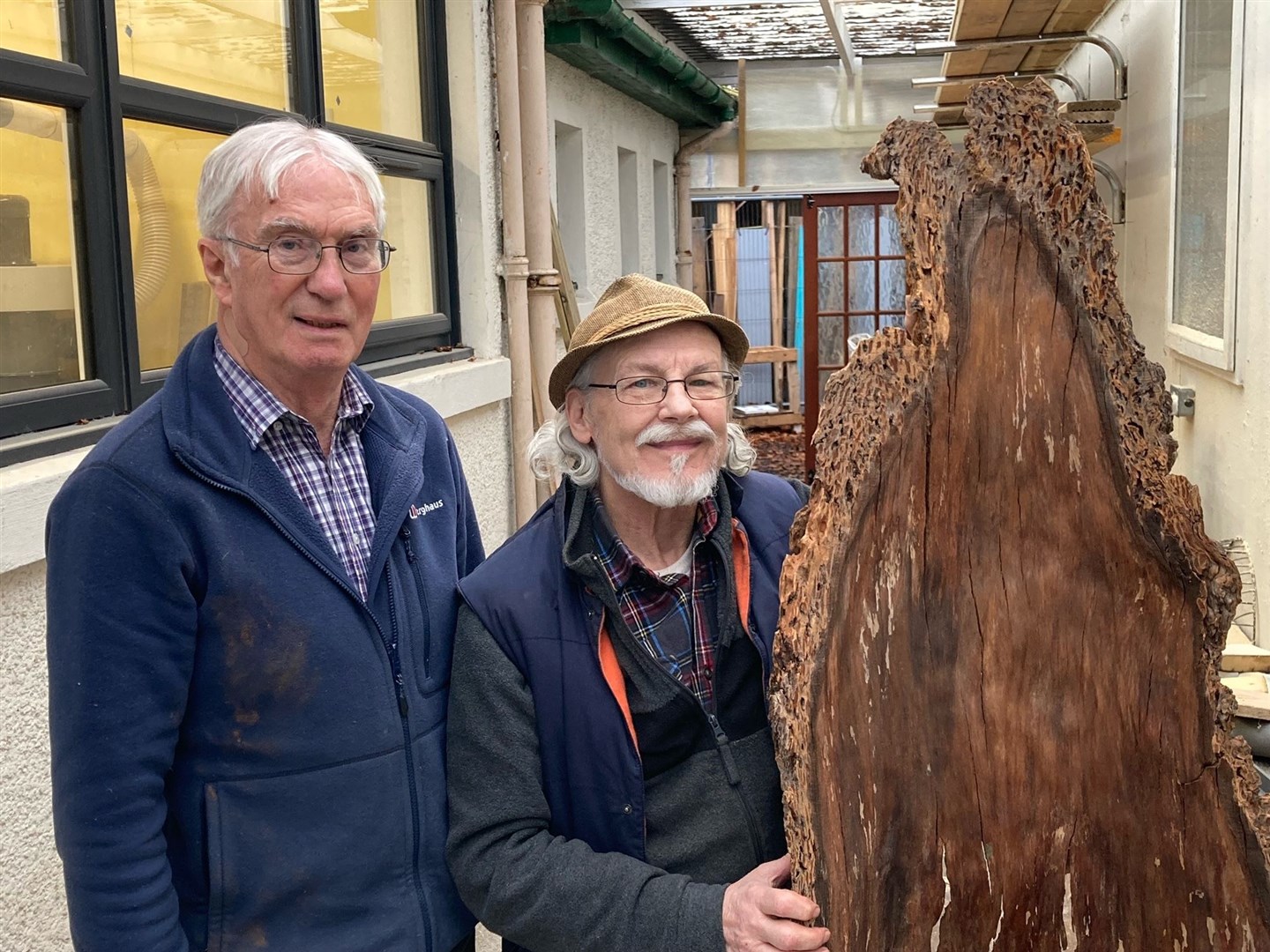Donald Macquarrie (left) and John McLeod with the piece of bark John is transforming into a chair.