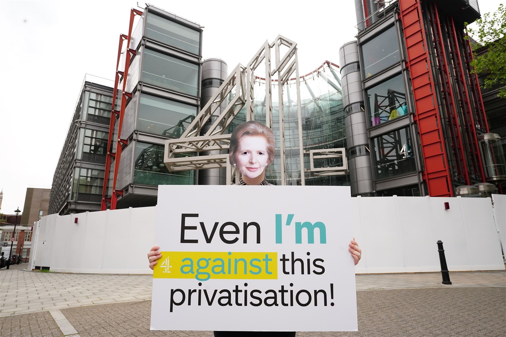 A protester wearing a mask of former prime minister Margaret Thatcher outside the Channel 4 London headquarters (Ian West/PA)