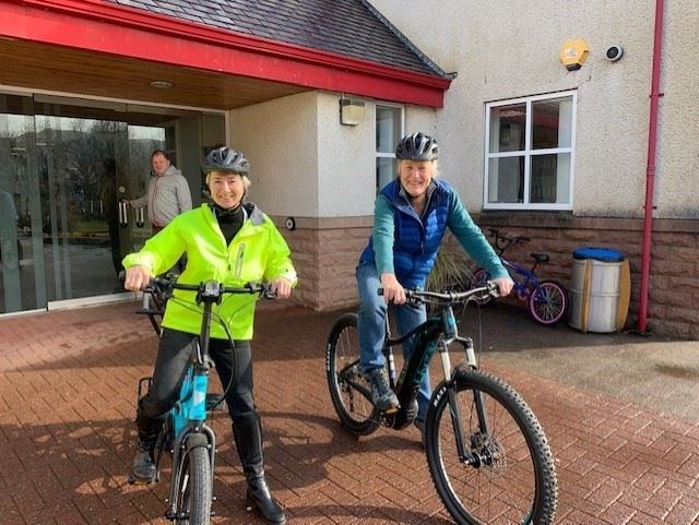 Ullapool Community Trust directors Amanda Barry-Hirst (left) and Flick Hawkins (UCT Chair), take electric bikes out for a spin. The E-bikes were provided by Square Wheel Cycles of Strathpeffer.