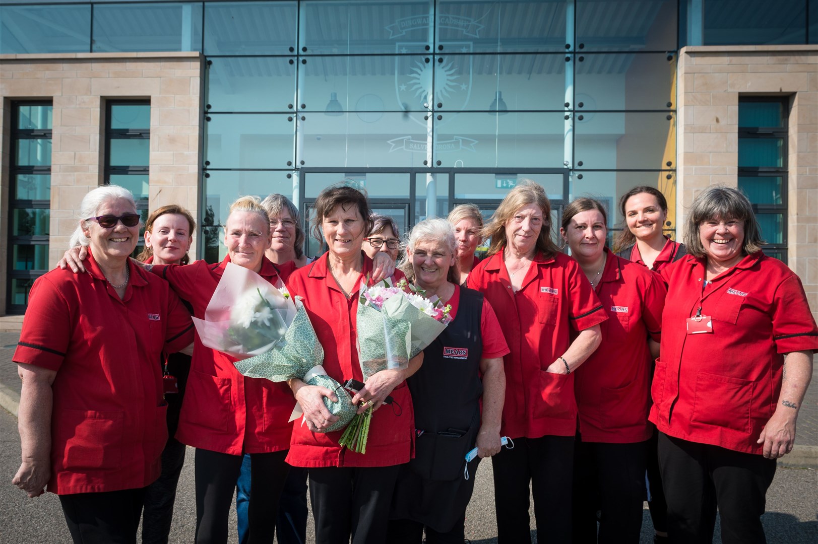 Mary Macallister (holding flowers) with work colleagues, retires after 20 years as a cleaner at Dingwall Academy..Picture: Callum Mackay..