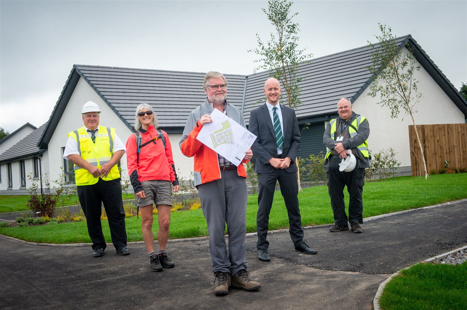 Tulloch Site Manager Jim Crawford with Penny Edwards and Paul Wadge, directors of Culbokie Community Trust, Tulloch Homes commercial director Kieran Graham and Simon Campbell, property investment co-ordinator with Cairn Housing Association. Picture: Callum Mackay
